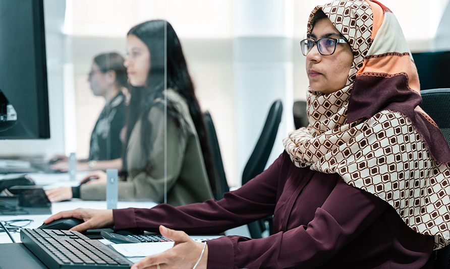 A woman works at a computer