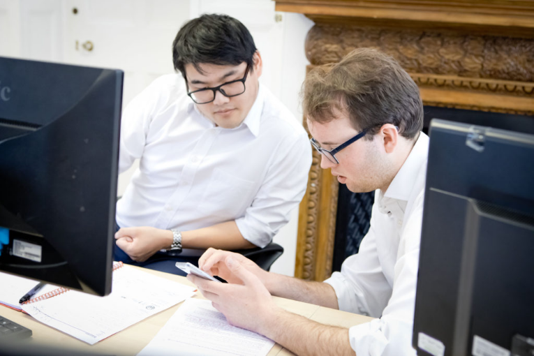 Two men at work in front of their computers